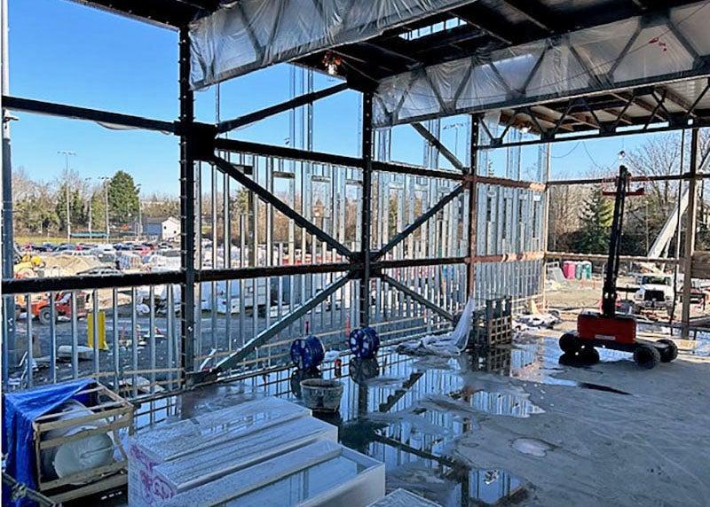 looking out through structural steel framing with metal studs on a building under construction